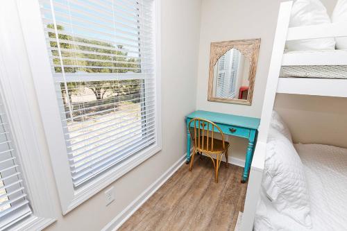 a bedroom with a blue desk and a window at Canalfront, water views, wild horses! 4x512, No Bad Days in Knotts Island