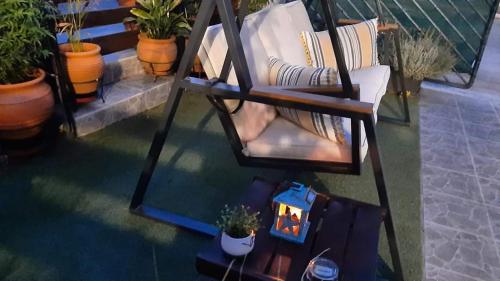 an overhead view of a chair on a balcony with plants at Zoe garden home in Spáta