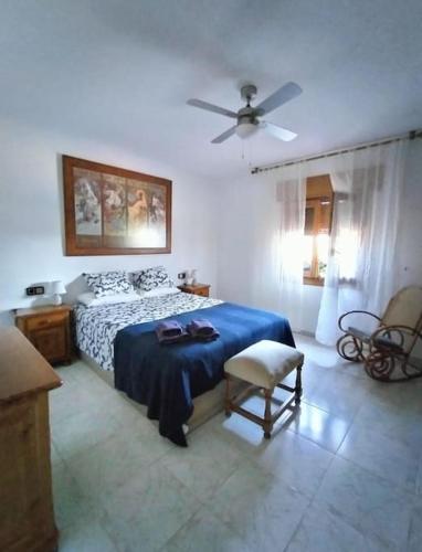 a bedroom with a bed and a ceiling fan at Cortijo El Ventorrillo de Agua Amarga in Almería