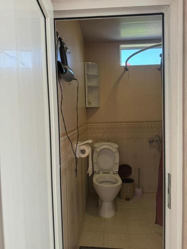 a bathroom with a white toilet in a room at Center in Goris