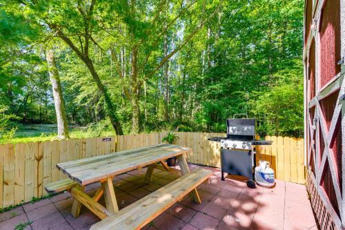 a picnic table and a stove in a backyard at Pet-Friendly Raleigh Tiny Home with Patio in Raleigh