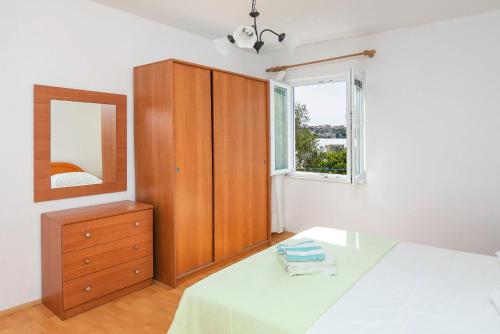 Postel nebo postele na pokoji v ubytování Apartments Sinisa