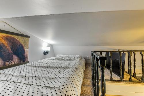 a bedroom with two beds and a staircase at Pet-Friendly Raleigh Tiny Home with Patio in Raleigh