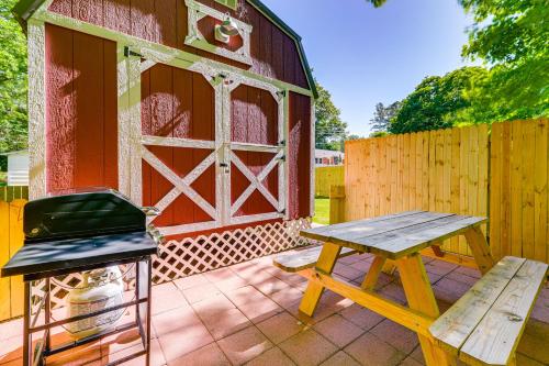 a picnic table and a grill on a patio at Pet-Friendly Raleigh Tiny Home with Patio in Raleigh