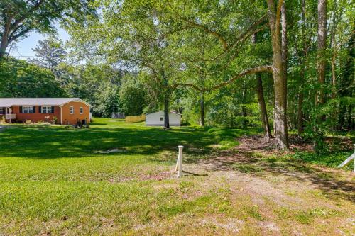 a yard with a house in the background with trees at Pet-Friendly Raleigh Tiny Home with Patio in Raleigh