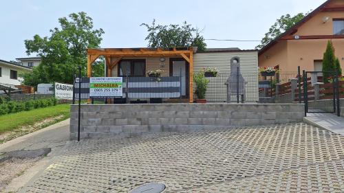 a house with a sign in front of it at Bungalows Michalka - Podhájska in Podhájska
