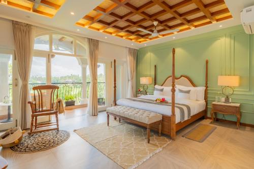 a bedroom with a bed and a chair at ELIVAAS 5 BHK Pet Friendly with Pvt Pool - Villa Vacasa in Calangute
