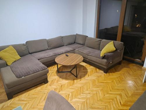 a living room with a couch and a table at Nena Apartment in Kumanovo