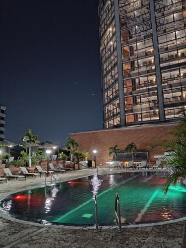 a swimming pool in front of a building at night at EXECUTIVE SUITES VALENCIA in Valencia