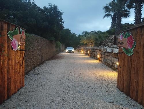 a car driving down a road with a fence at La Pura Vida 34 in Pignan