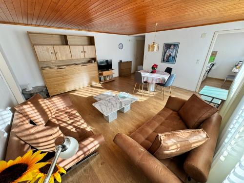 a living room with a couch and a table at Rosenhaus Baccara in Oberhofen am Thunersee