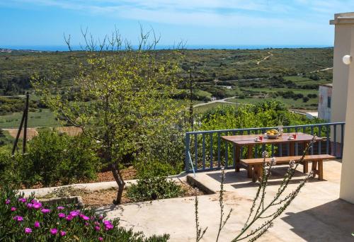a view from the balcony of a house with a table and flowers at Volari house in Kýthira