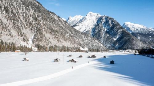 a snowy mountain range with houses in the snow at Haus Monika in Scharnitz