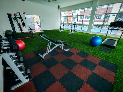 a room with a gym with exercise equipment and grass at Pavilionvillie M1T570 by irainbow in Ipoh