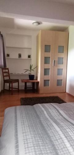 a bedroom with a bed and a chair and a table at Haus Monika in Scharnitz