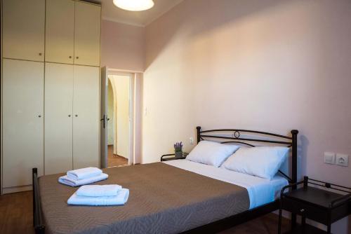 a bedroom with a bed with two towels on it at Volari house in Kýthira
