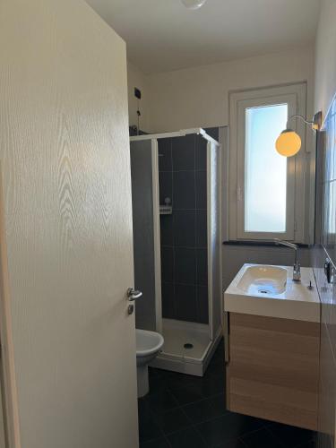 a bathroom with a sink and a toilet and a shower at CYTRUS apartament in Marina di Massa