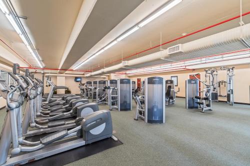 a gym with lots of treadmills and machines at Majestic Beach Resort Tower I by Panhandle Getaways in Panama City Beach