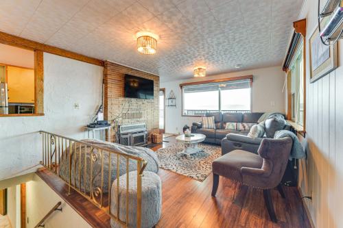 a living room with a couch and a table at Beachfront Anderson Island Escape Rainier Views! in Beachcrest