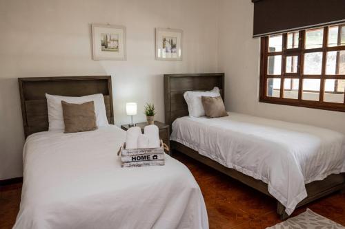 two beds in a room with white sheets at Country house, Cozy Fireplace and an amazing view in Cartago