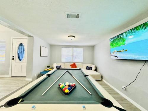a living room with a pool table and a tv at Game Night Ready Lakeland Stay Near Colleges in Lakeland