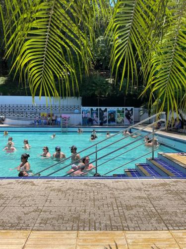 a group of people in a swimming pool at Suíte dos Sonhos - Suíte climatizada - Romântica, única e meio à natureza! in Piratuba