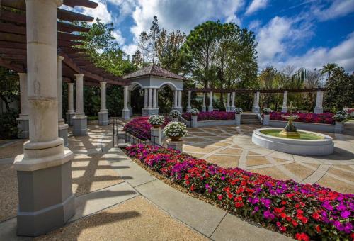 a garden with flowers and a gazebo at Lakeland Retreat King Bed Pet Friendly Yard in Lakeland