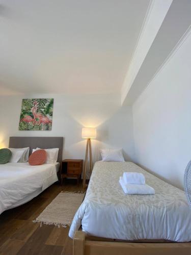 a bedroom with two beds and a lamp in it at Casa Pavão in Pilar
