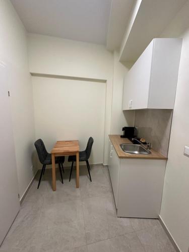 a small kitchen with a table and a sink at DATRI Petite Suite 6 in Vienna
