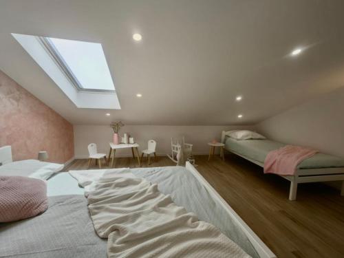 a attic bedroom with two beds and a skylight at Green View Apartment in Vrh