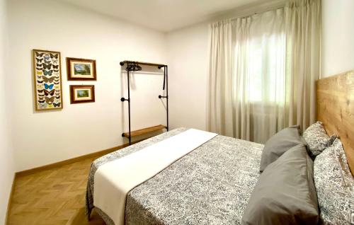 a bedroom with a bed in front of a window at PTHouse in Badia Prataglia