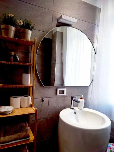 a bathroom with a sink and a mirror at Al Teatro Suites in Foggia