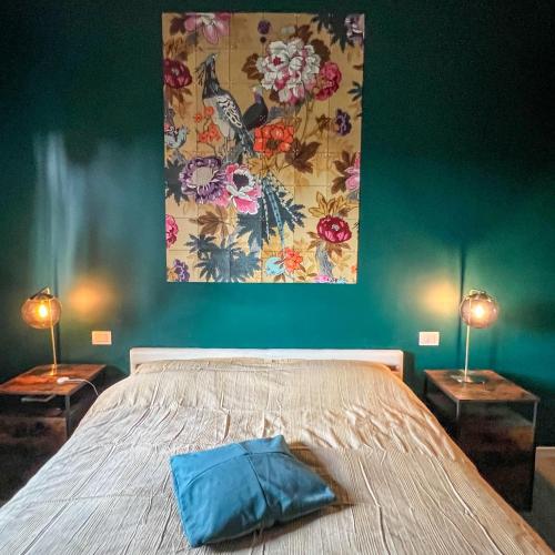 a bedroom with a large bed with two lamps at B&B La Fontana in Spilamberto