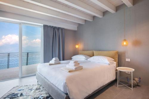 a bedroom with a large bed and a large window at Only Adult Villa Montelago With Pool in Pai