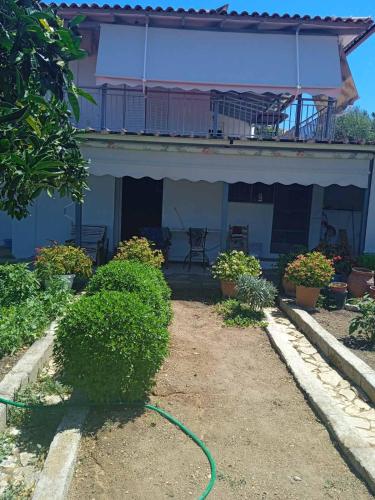 a garden hose in front of a house at Katerina house in Akritokhórion