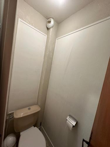 a small bathroom with a toilet and a roll of toilet paper at Résidence Les Milandes in Cazaubon