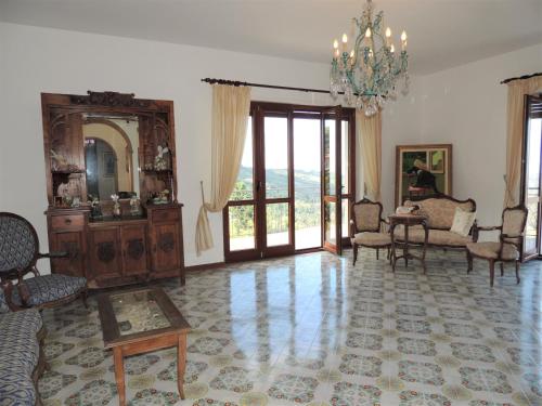 a living room filled with furniture and a chandelier at Residenza Panoramica Villa Carmela in Rocca Cilento