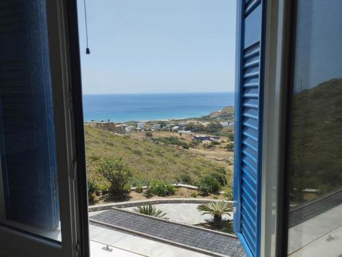 a view of the ocean from a window at Villa Helen in ayios Petros