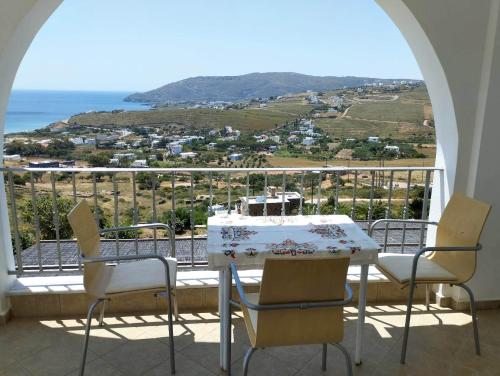 a table and chairs on a balcony with a view of the ocean at Villa Helen in ayios Petros