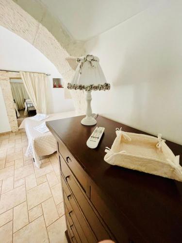 a bedroom with a table with a lamp on it at Trulli Ada in Noci