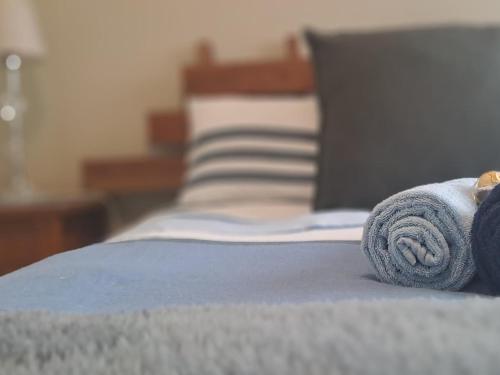a towel laying on top of a bed at Middelbult Guesthouse by Heybert in Secunda