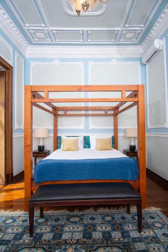 a bedroom with a bed with a wooden bed frame at Casa das Amendoeiras in Silves