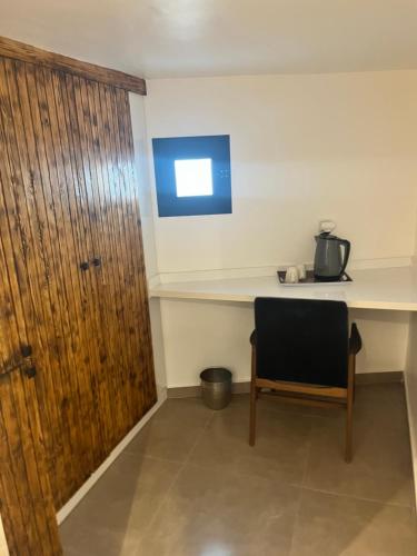 a room with a desk and a chair and a door at Dar L'hna in Marrakech