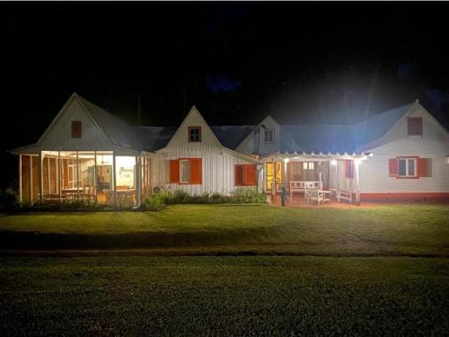 a house with lights on the front of it at night at Estancia Las Mercedes in Eldorado