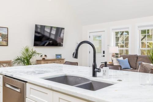 a kitchen with a sink and a counter top at Tranquil Mountain Escape Luxurious 2 Bedroom 2 Bath Cottage on 9 Acres in Maryville