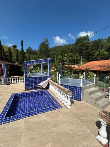a set of blue tiles on a patio with at Chales em Salesopolis - Recanto da Barra in Salesópolis