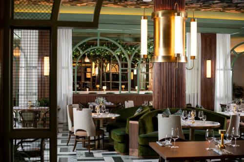 a restaurant with tables and chairs and a chandelier at Beau Rivage Resort & Casino in Biloxi
