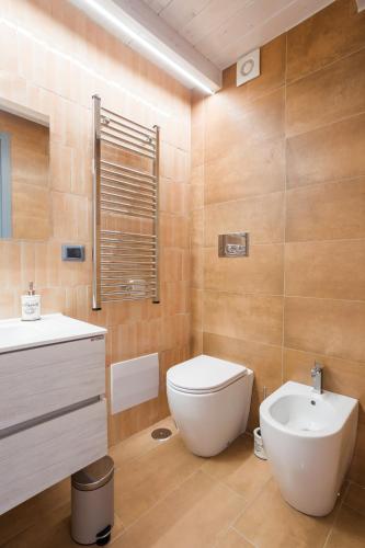 a bathroom with a white toilet and a sink at Domus Xenia in San Giorgio a Cremano