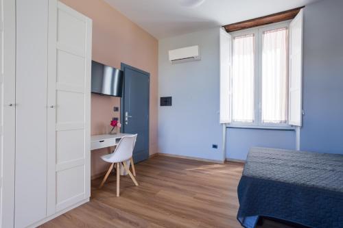 a bedroom with a bed and a desk and a table at Domus Xenia in San Giorgio a Cremano