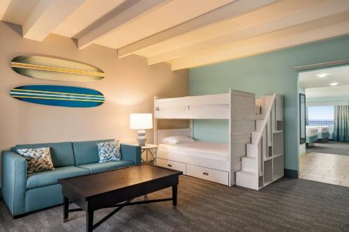 a living room with a couch and a bunk bed at Holiday Inn Resort Jekyll Island by IHG in Jekyll Island